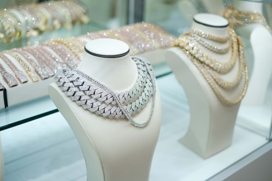 Diamond necklaces displayed on busts in a jewelry store.